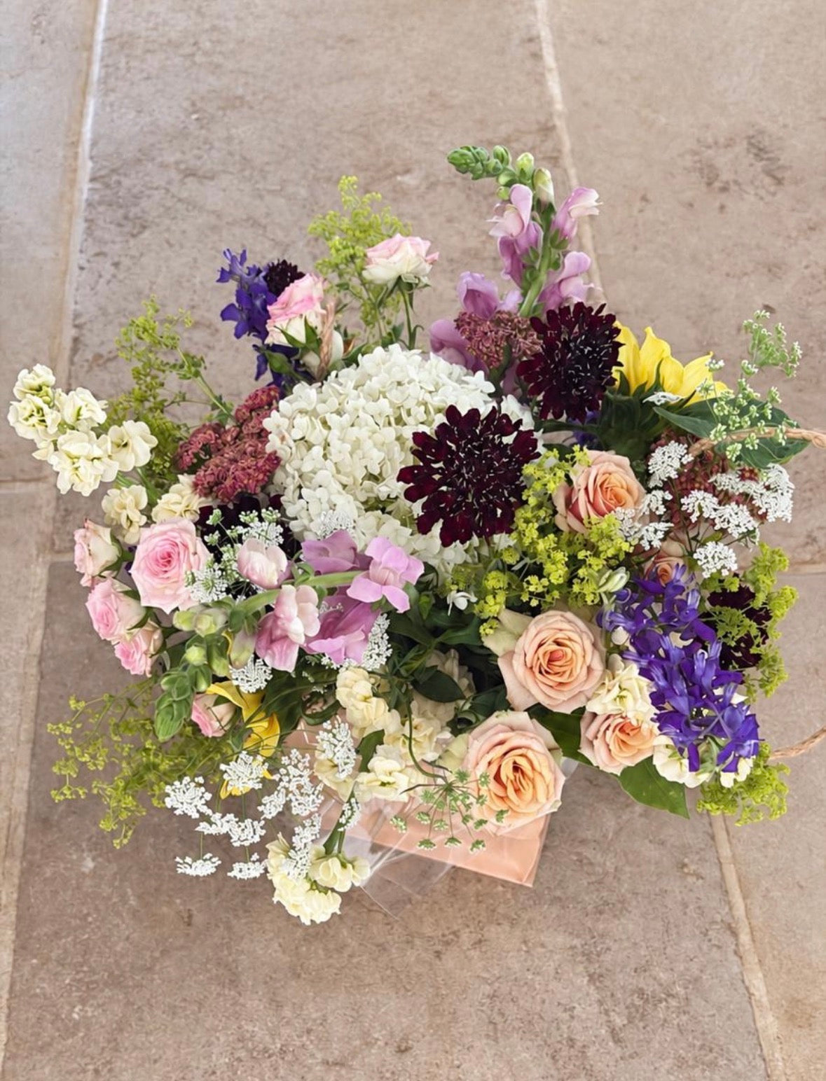 Botanica seasonal bouquet photographed on a hallway floor