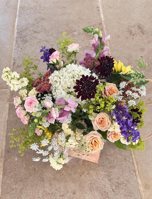 Botanica seasonal bouquet photographed on a hallway floor