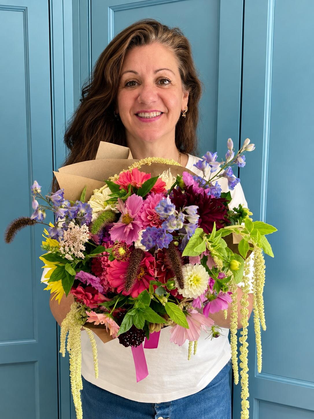 Lucy holding a seasonal Botanica bouquet